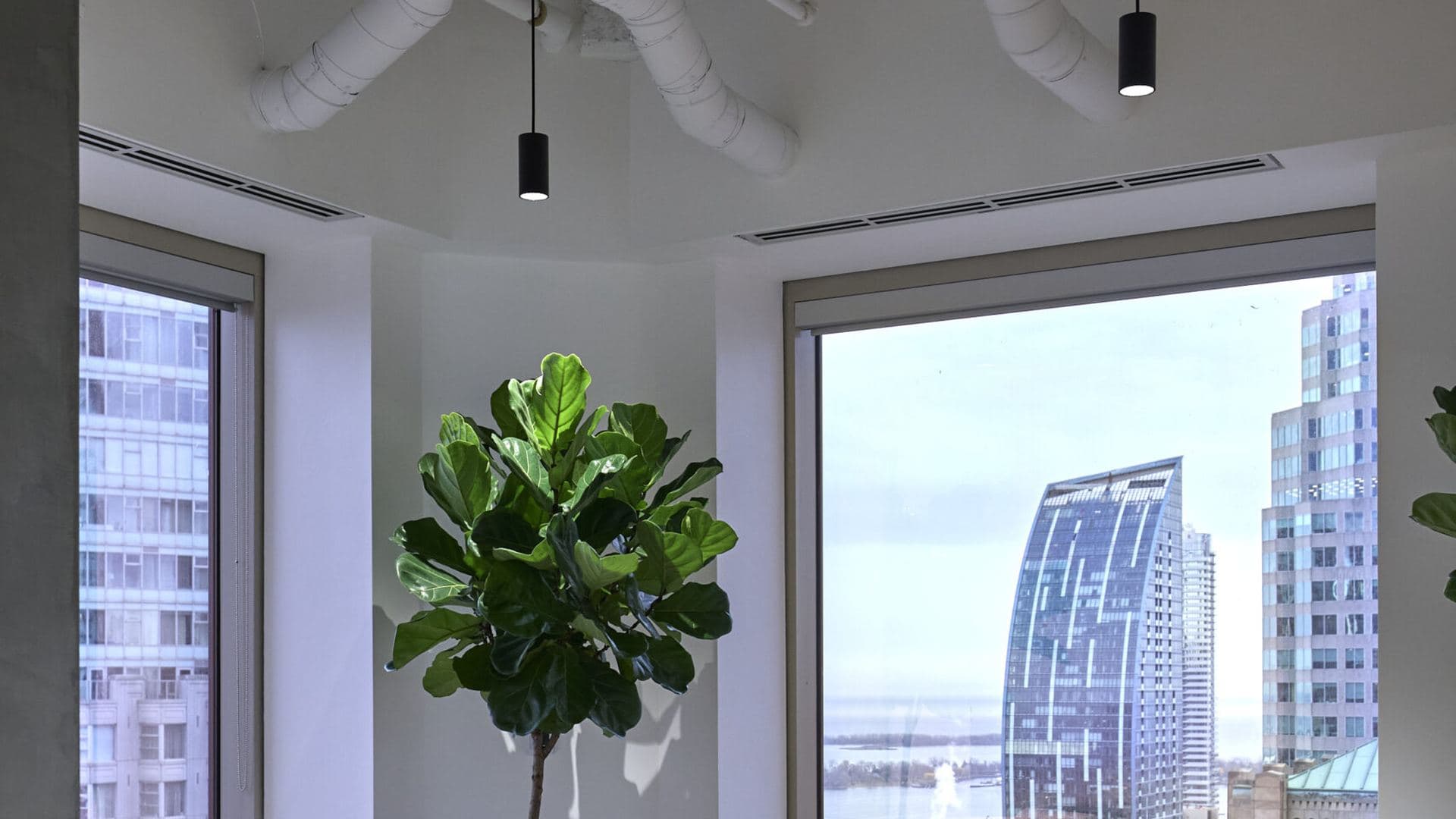 An office interior, desks and windows in landscape.